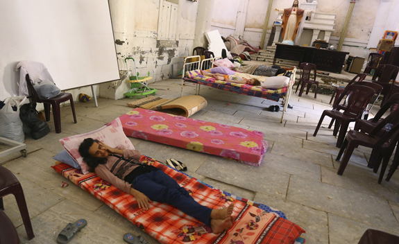Iraqi Christian family fleeing Mosul sleeps inside Chaldean church